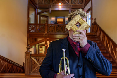 Fine Art photographer David Lee Black portrait of trumpeter Doug Woolverton, eye, trumpet at Newport Art Museum, Newport, Rhode Island. 