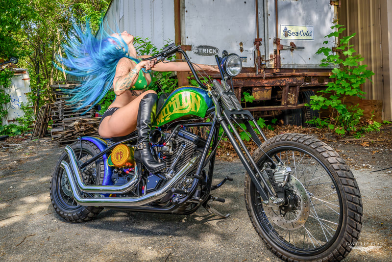 Blue-haired bikini model on custom chopper motorcycle photographed by David Lee Black. 