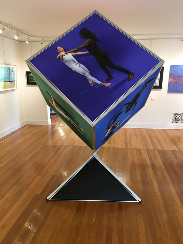 Noted fine art photographer and sculpture artist David Lee Black collaborates with Vermont fine art painter Matthew J. Peake with the Outside the Box Project involving an 8 ' tall cube showing six sides of the human forms. 