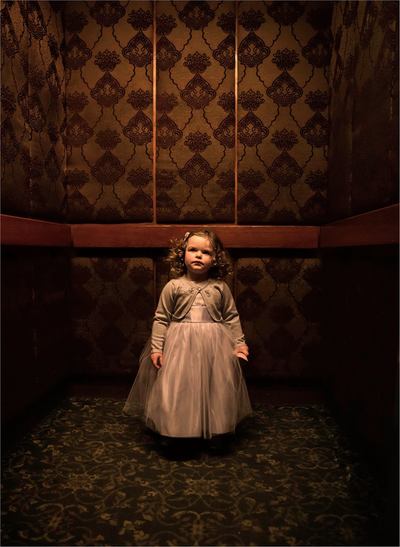 Fine Art photographer David Lee Black portrait of little girl in haunted elevator, Hawthorn Hotel, Salem, Massachusetts. 